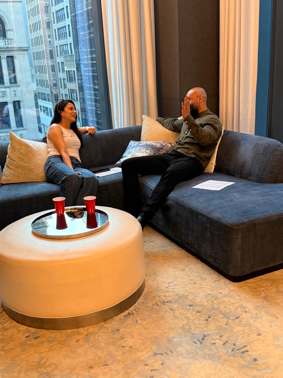 Two attendees talking on a lounge sofa at Wavelength